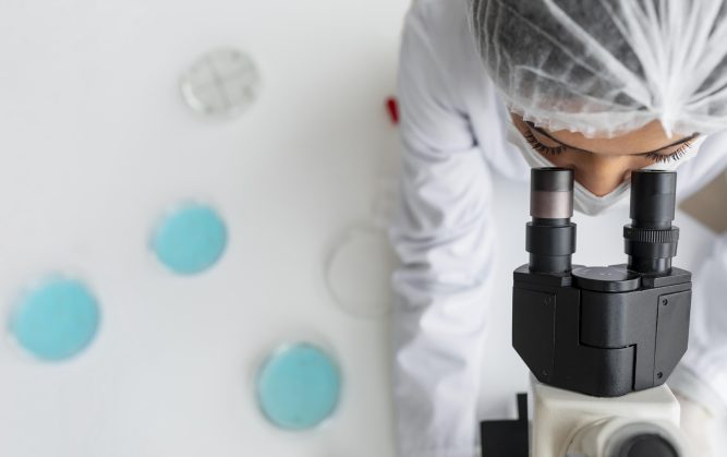 close-up-researcher-looking-through-ocular-lens